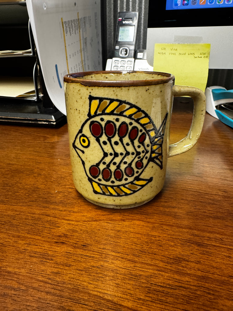 Vintage stoneware mug with fish design